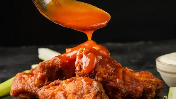 All You Need To Amp Up Classic Buffalo Sauce Is A Little Roasted Garlic