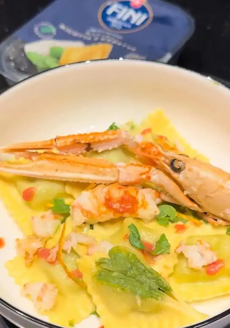 Ricotta and herb ravioli with shellfish emulsion, orange scampi and asparagus tips