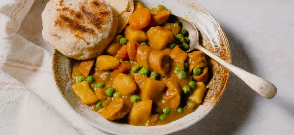 Curried sausages with Johnny cakes