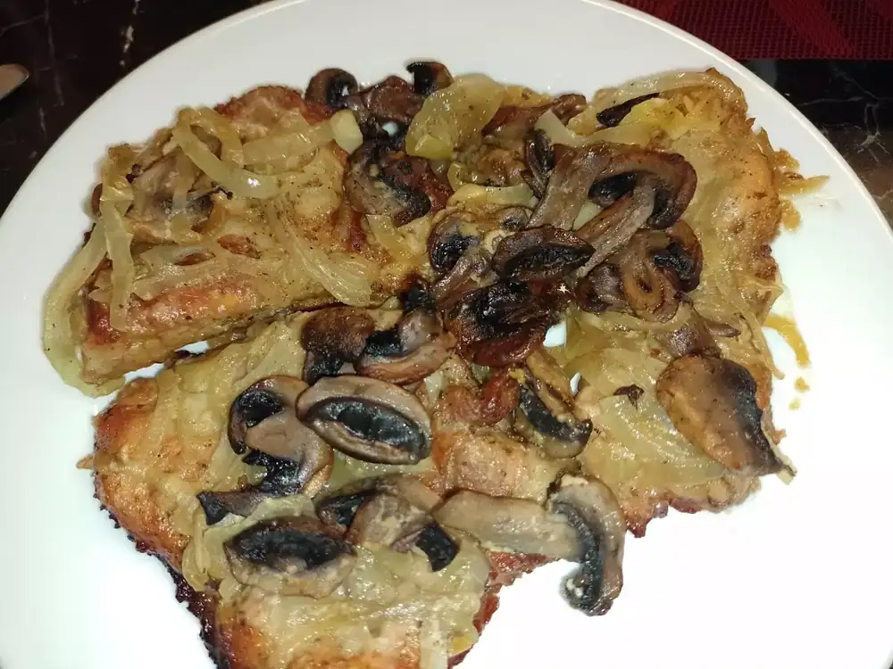 Juicy steaks with mushrooms in the oven