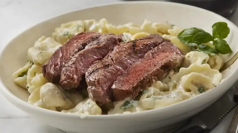 Here's Why You Won't Traditionally See Pasta Served Alongside Steak In Italy