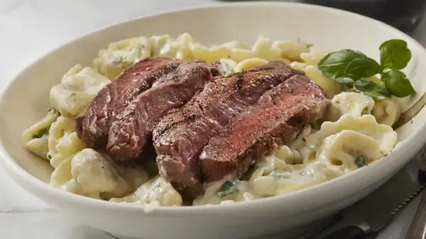 Here's Why You Won't Traditionally See Pasta Served Alongside Steak In Italy