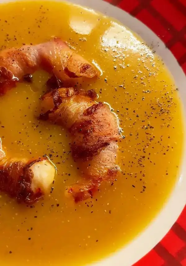 Bacon-wrapped prawns on pumpkin cream