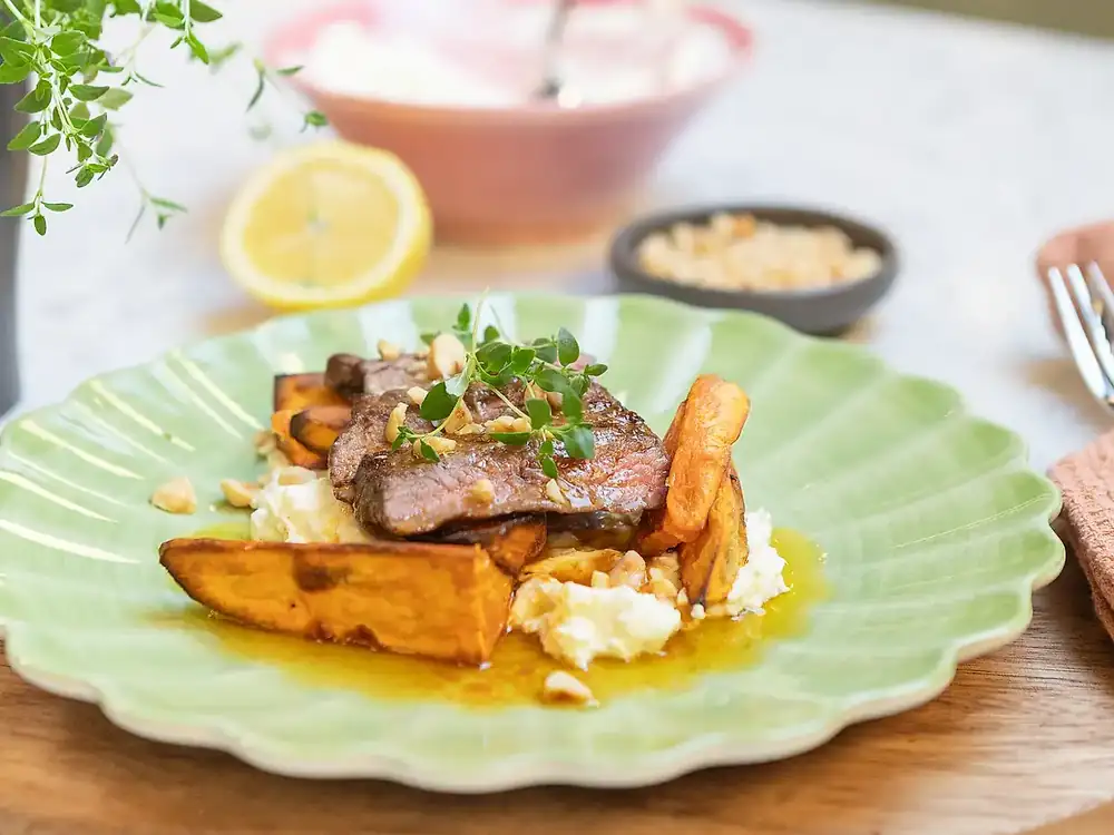 Sirloin steak with roasted sweet potatoes, harissa butter and feta cheese cream