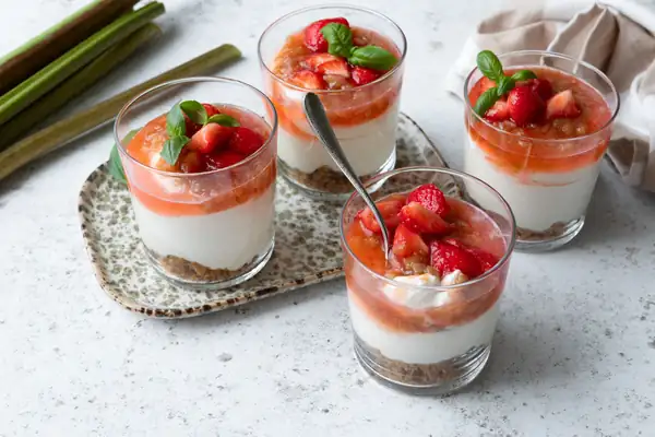 Cheesecake in a glass with rhubarb and strawberries