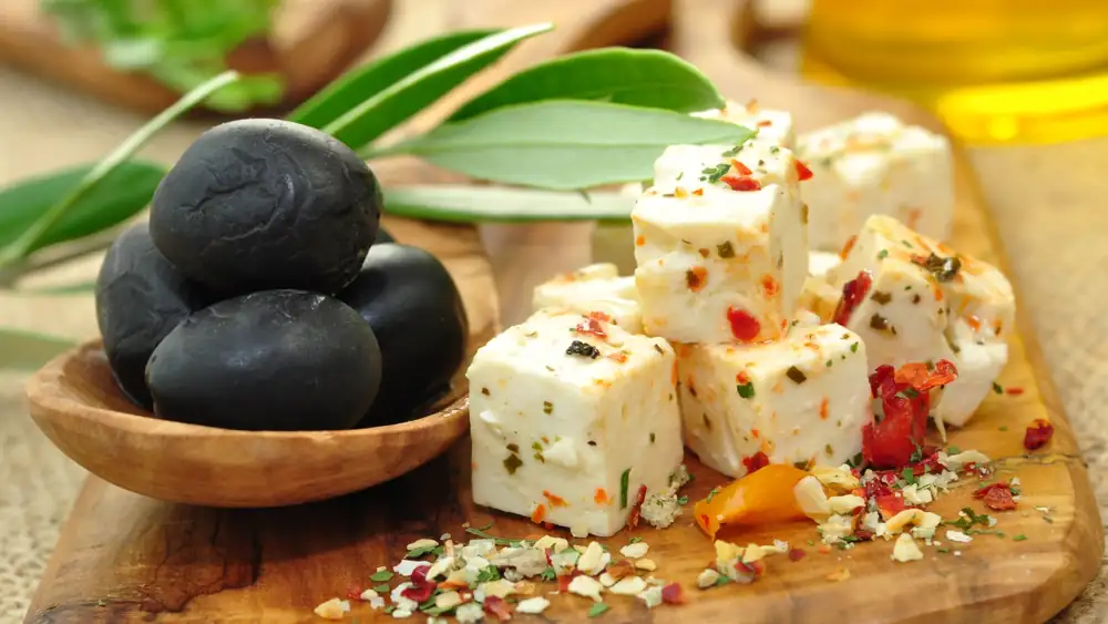 Quick appetizer of cheese with spices and black olives