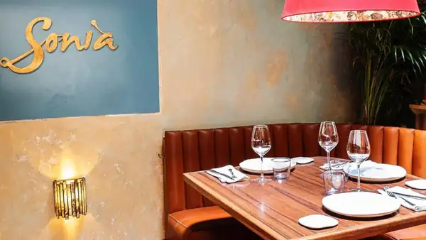 Sonia sets the table for the Mexican wine