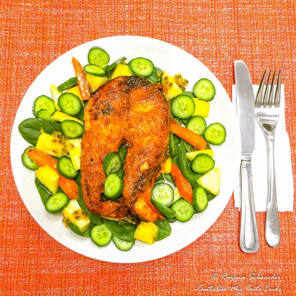 Baked salmon steak with spinach salad