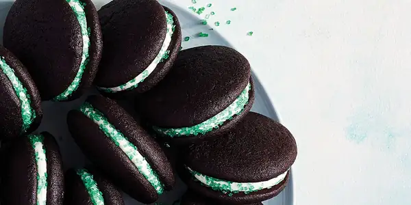Pastelitos Whoopie de chocolate con forma de saltamontes y crema de mantequilla verde menta