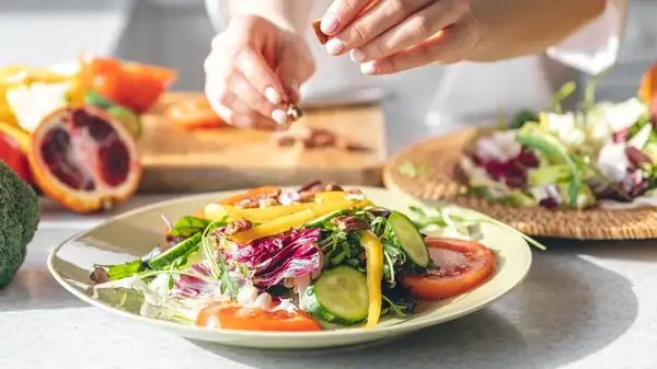 Why It's Better To Toss Salad With Your Hands Instead Of Tongs