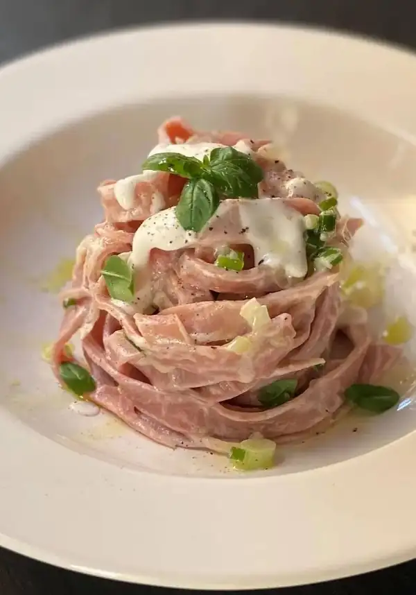 Beetroot fettuccine with goat cheese cream and green onions