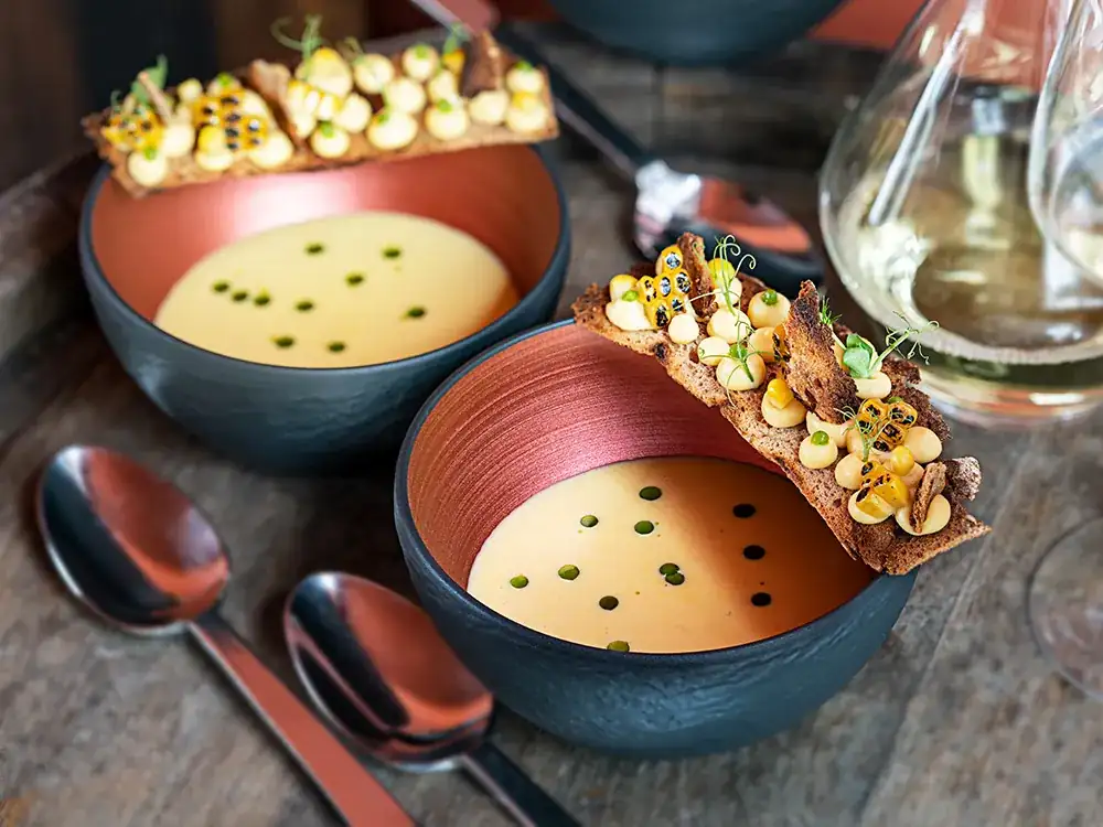 Corn cream soup with bay leaf, Silvaner wine and bread chips