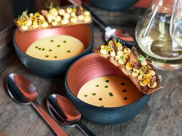 Corn cream soup with bay leaf, Silvaner wine and bread chips