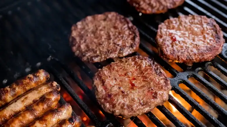 Why It's So Much Harder To Cook Burgers On A Charcoal Grill
