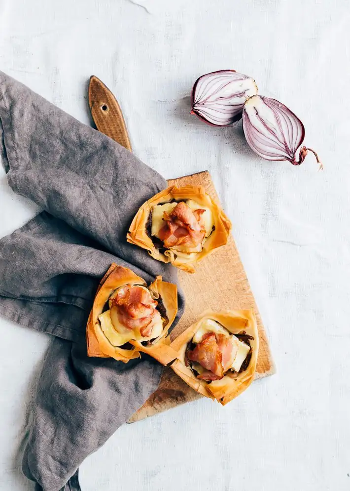 Filo pastry cups with caramelized red onion, brie, and bacon