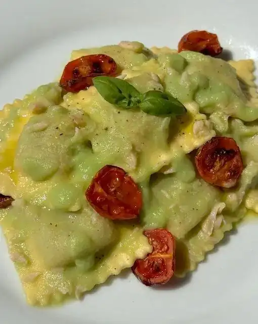 Ricotta and herb ravioli with creamed Romanesco broccoli, smoked salmon, and semi-dried cherry tomatoes