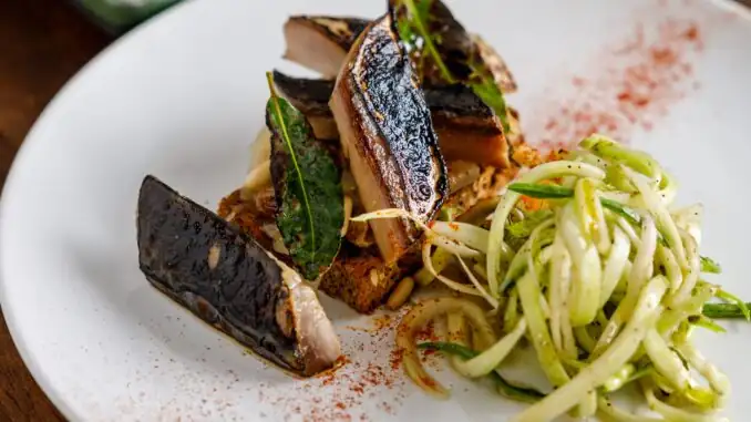 Caballa sellada, cebollas en salsa saor, pan de espelta y puntarelle, la receta de Menabó Vino e Cucina