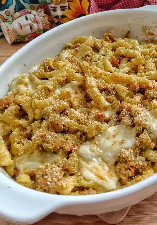 Baked busiate with wild fennel pesto, dried tomatoes, seasoned Sicilian sausage and Caciocavallo cheese