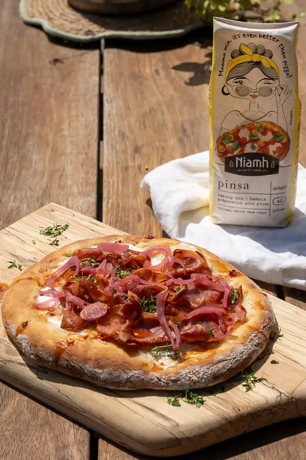 Pinsa with goat cheese, Serrano ham and hot honey