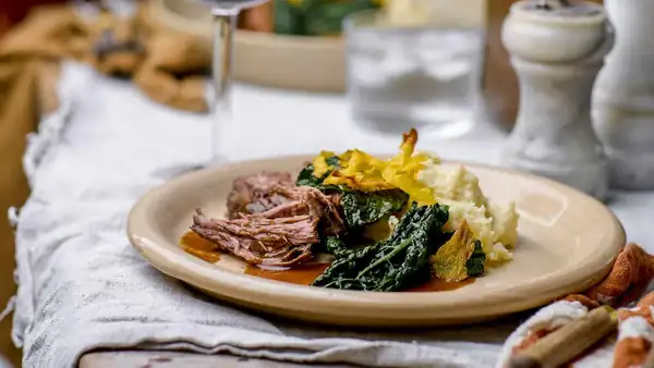 Overnight baked prime rib with red wine sauce, celeriac puree and butter-fried black cabbage