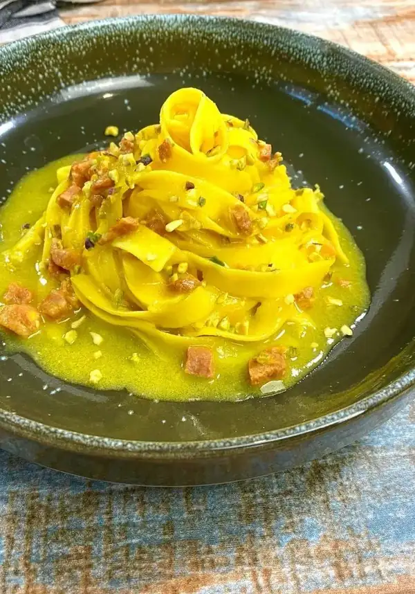 Fettuccine with sausage, saffron, and pistachio