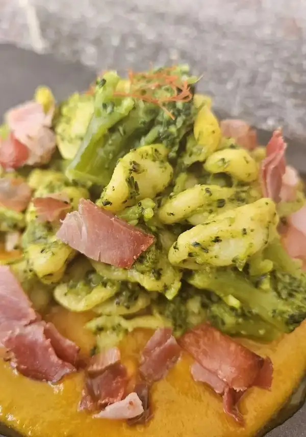 Saffron orecchiette with broccoli, pumpkin cream and crispy speck