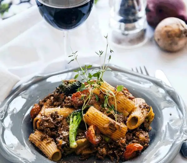 Pasta with minced beef ragu and baked tomatoes