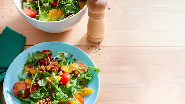 How creative is that? We top an orange and tomato salad with arugula with salted granola!