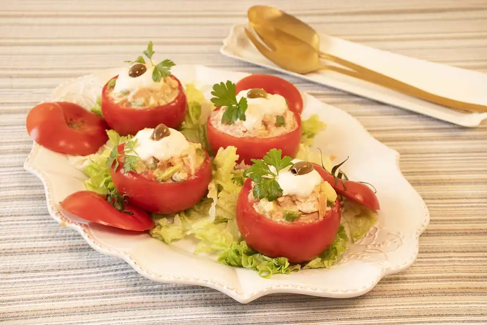 Tomatoes stuffed with fresh salmon, avocado and apple