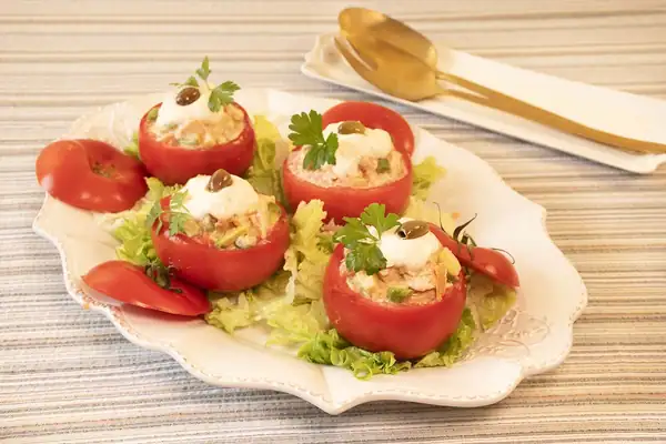 Tomatoes stuffed with fresh salmon, avocado and apple