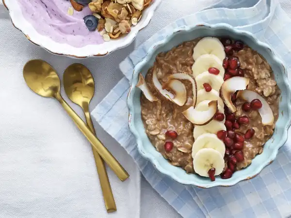 Chocolate coconut porridge with banana and pomegranate
