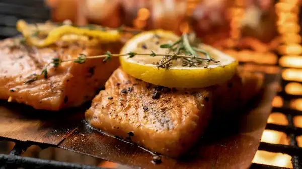 Andrew Zimmern's Go-To Technique For Grilling Chicken And Fish