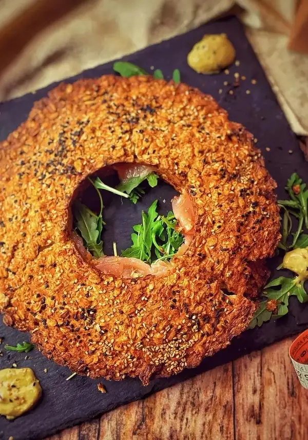 Oatmeal donut with salmon and arugula
