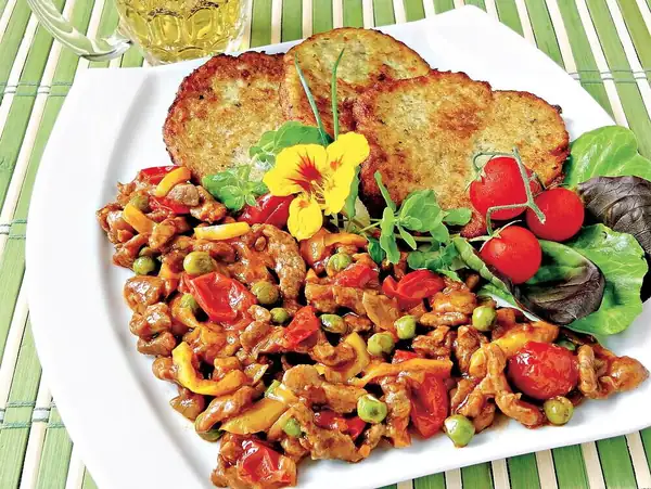 Fiery pork leg with potato pancakes