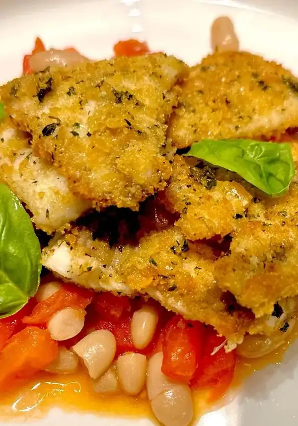 Breaded sea bream fillet, cannellini bean sauce and diced tomatoes