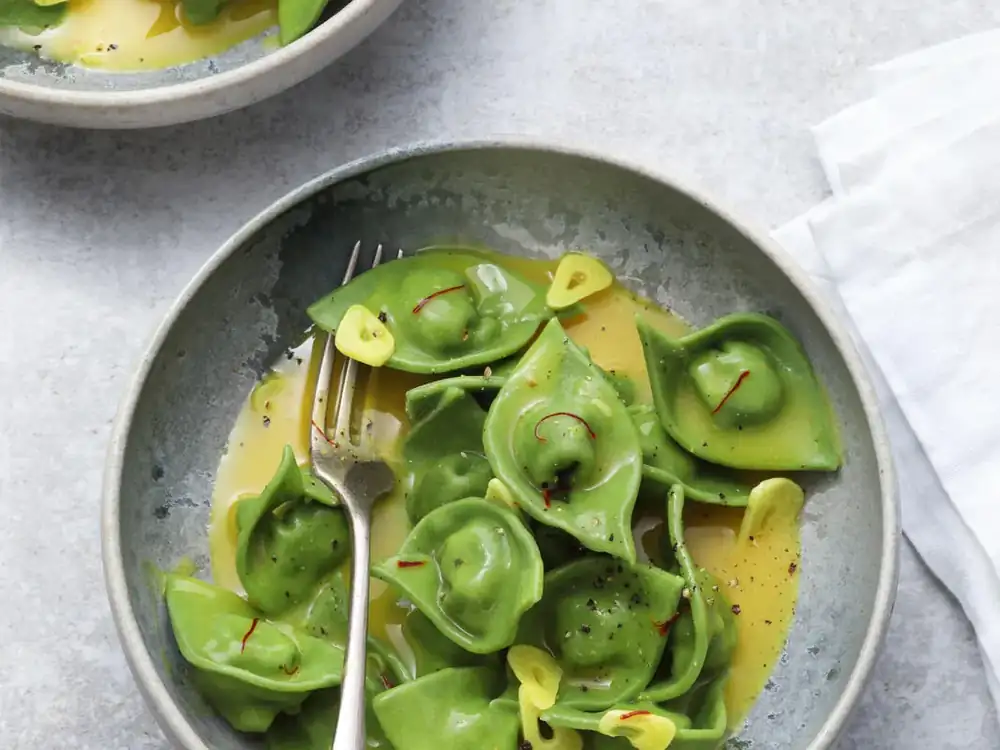 Chicken and spinach tortellini in saffron curry broth