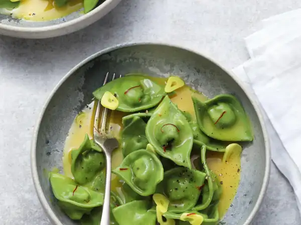 Chicken and spinach tortellini in saffron curry broth