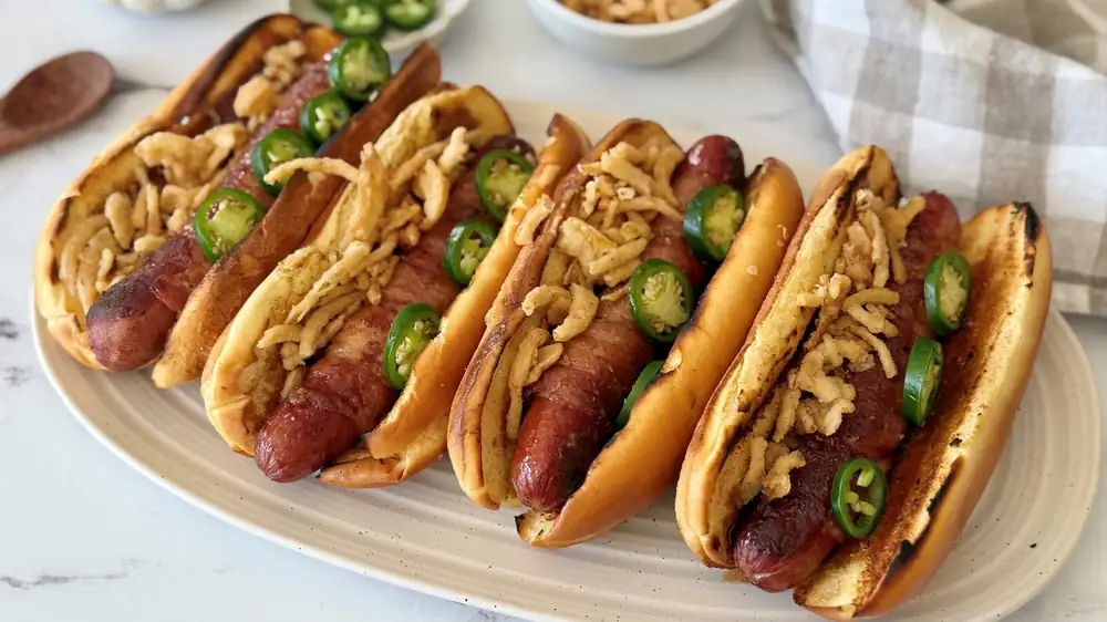 These Bacon-Wrapped Hot Dogs Bring Sweet, Smoky, And Spicy Flavor To The Grill