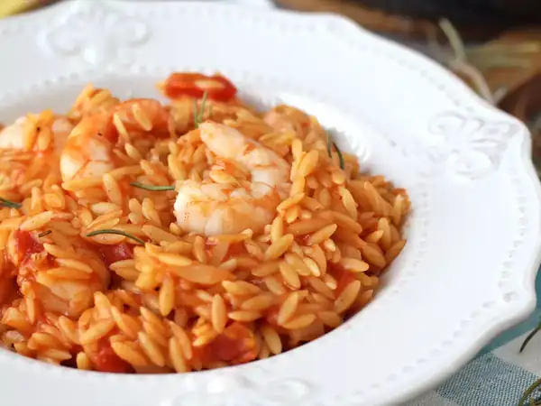 Orzo pasta with tomato and prawns, cooked in the style of a risotto