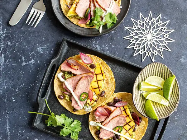 Duck tacos with black beans, avocado and grilled mango