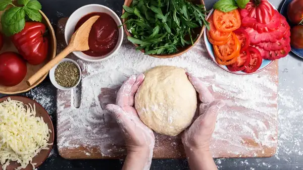 The Liquid To Always Keep In Your Workspace When Stretching Pizza Dough