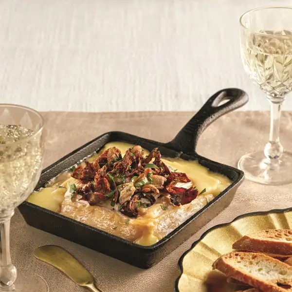 Oven-roasted cheese with a mushroom and herb topping