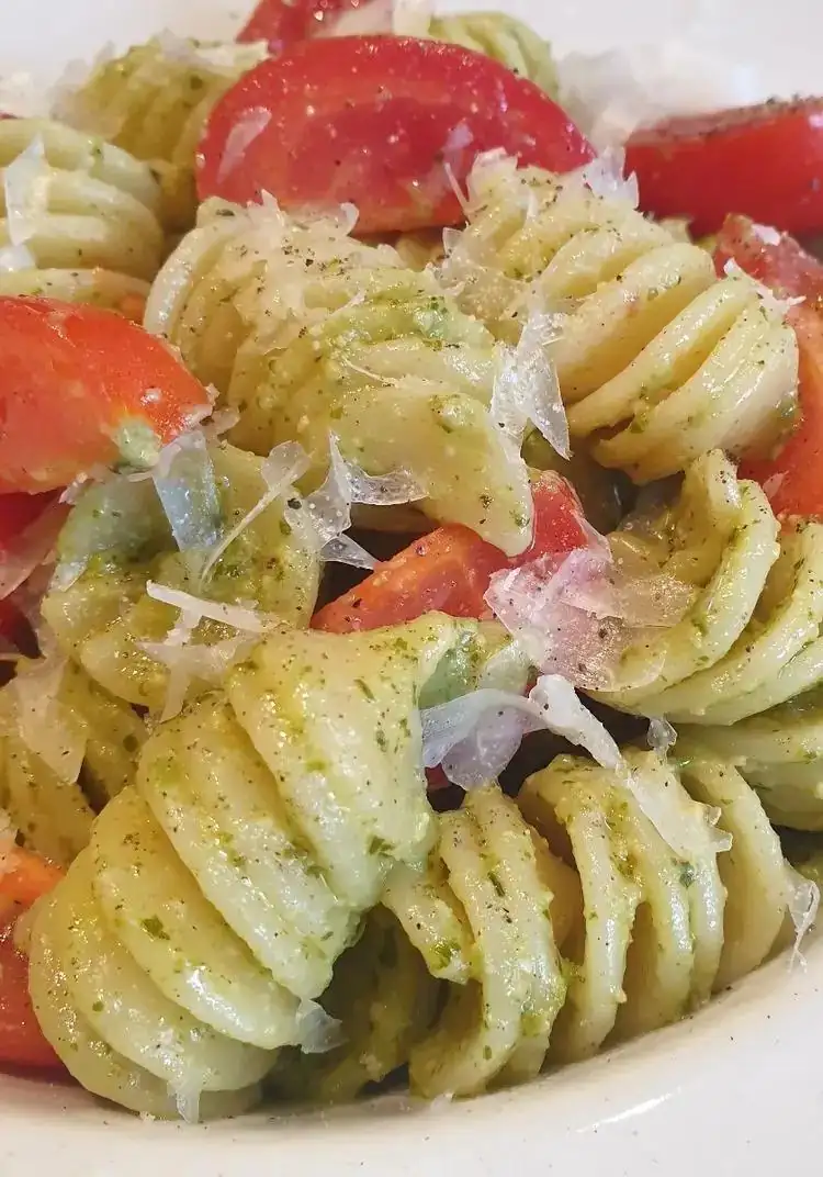 Fusilloni with pesto, cherry tomatoes and pecorino cheese flakes
