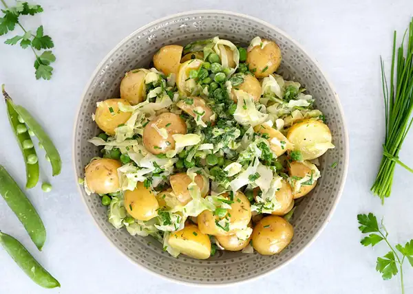 Warm potato salad with cabbage and peas
