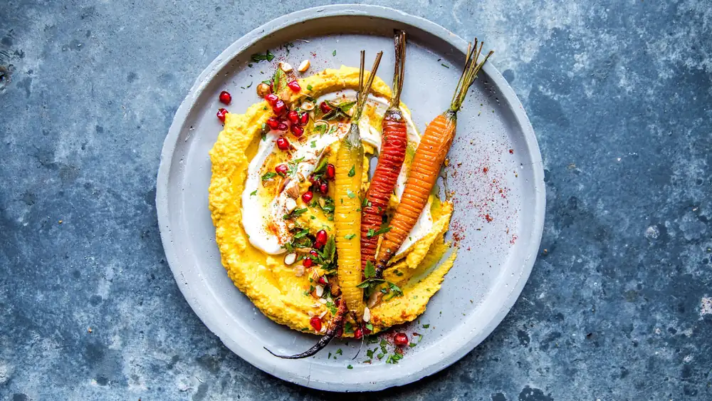 Hasselback carrot with carrot hummus