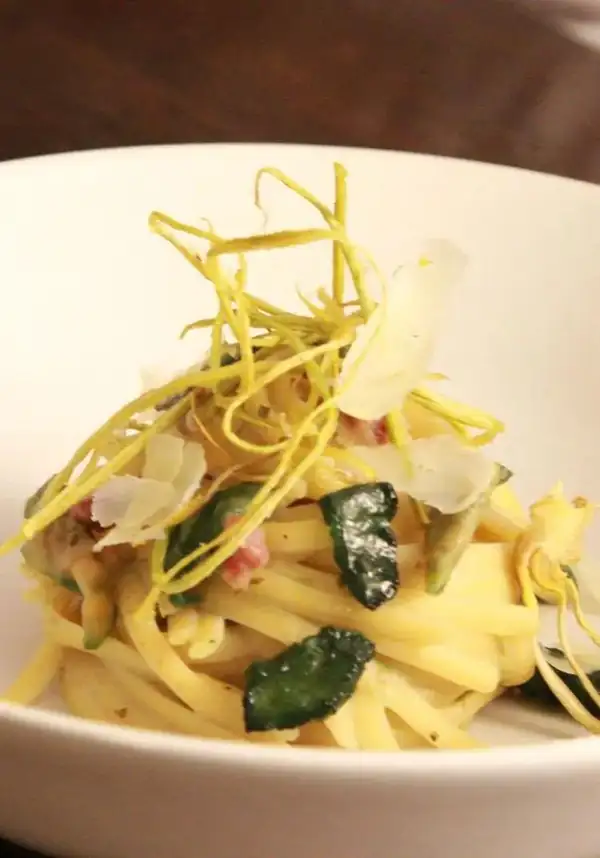 Linguine in creamed artichoke and potato sauce with chopped sausage, pecorino cheese puff pastry and artichoke chips