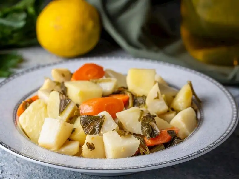 What can be done to prevent celery cooked in olive oil and orange from turning brown?