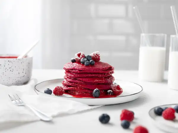 Pink pancakes with raspberry sauce