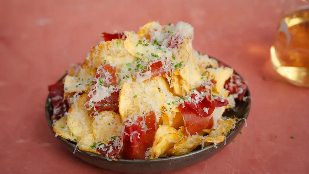 Chip tower of plain chips, Manchego, Iberico ham, and hot honey