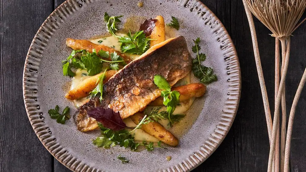 Baking potatoes and parboiling dumplings define German trout with Schupfnudeln